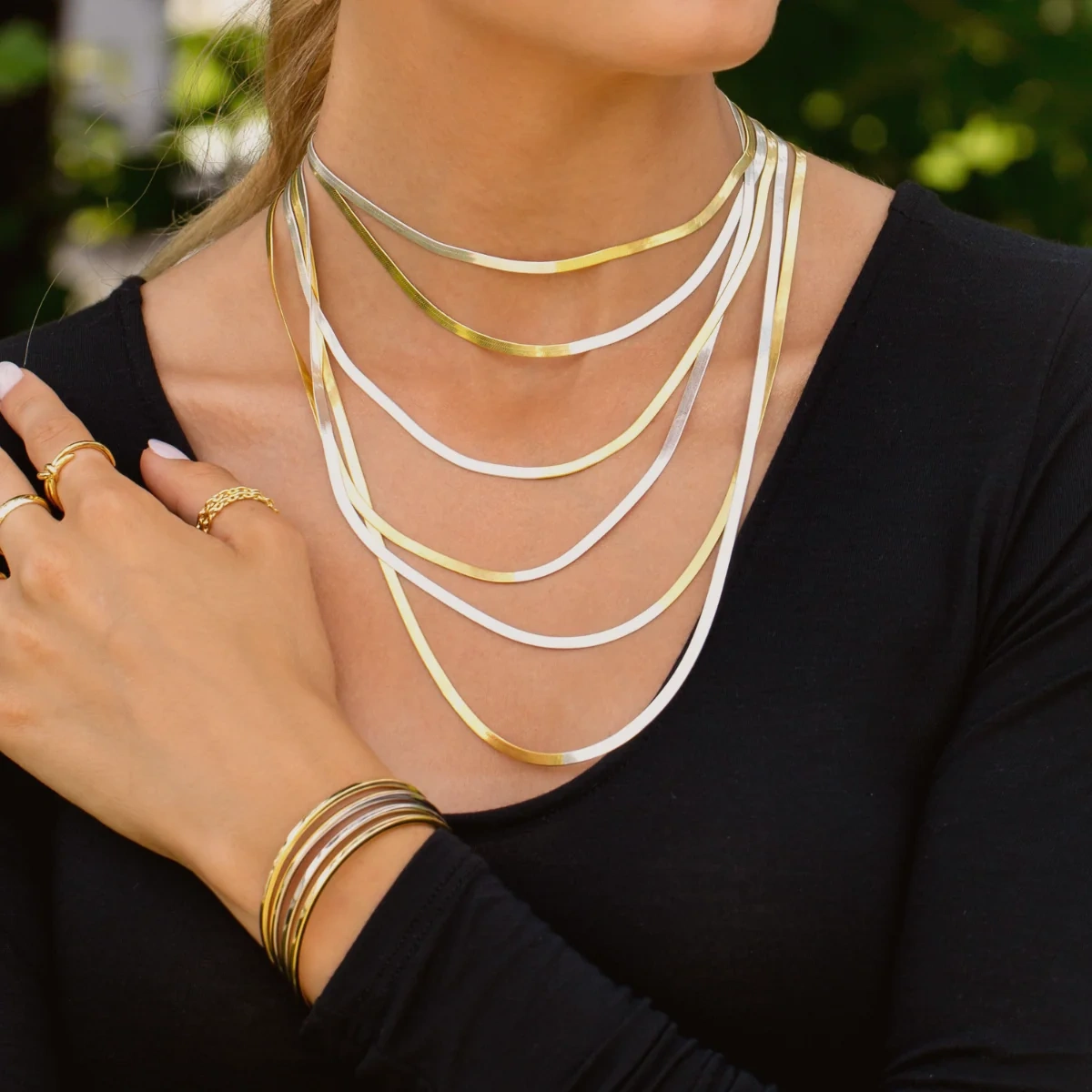 Gold chains layered at the neckline